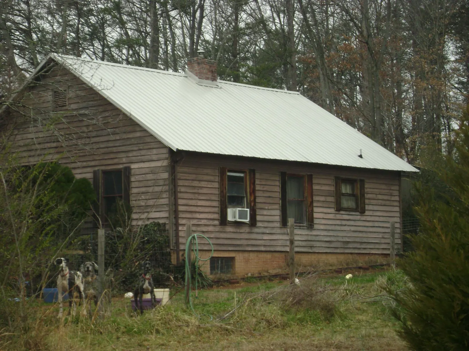 White metal roof on an old wood sided farmhouse, from a Metal Roof Installation job in Wilmore
